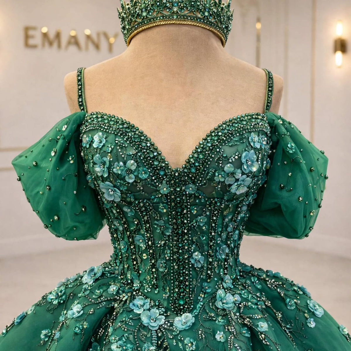  Close-up of the crystal beadwork and 3D floral appliqués on the Amara green wedding gown.