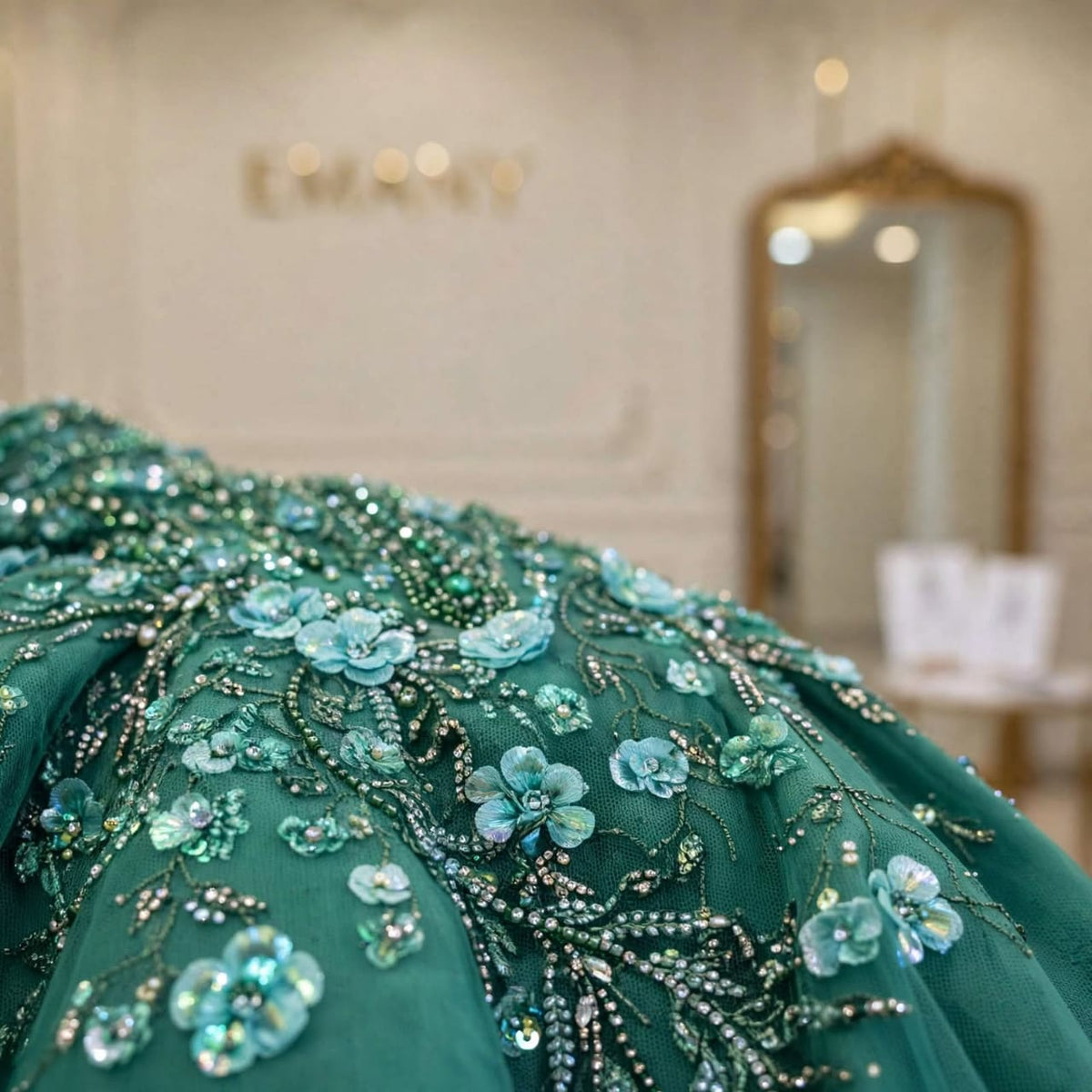 Macro detail of the sparkling crystals and flowers on the Amara emerald green tulle.