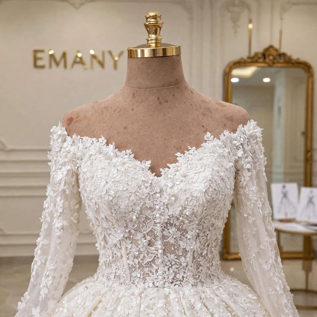 Close-up detail of the 3D floral lace and pearl beading on the off-shoulder bodice of the Celestia gown.
