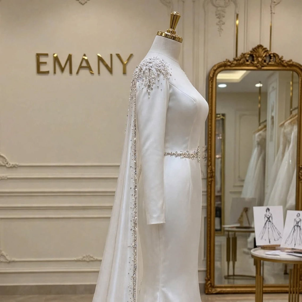 Side profile of the Elara modern modest wedding dress, showing the graceful mermaid silhouette and long sweeping train.

