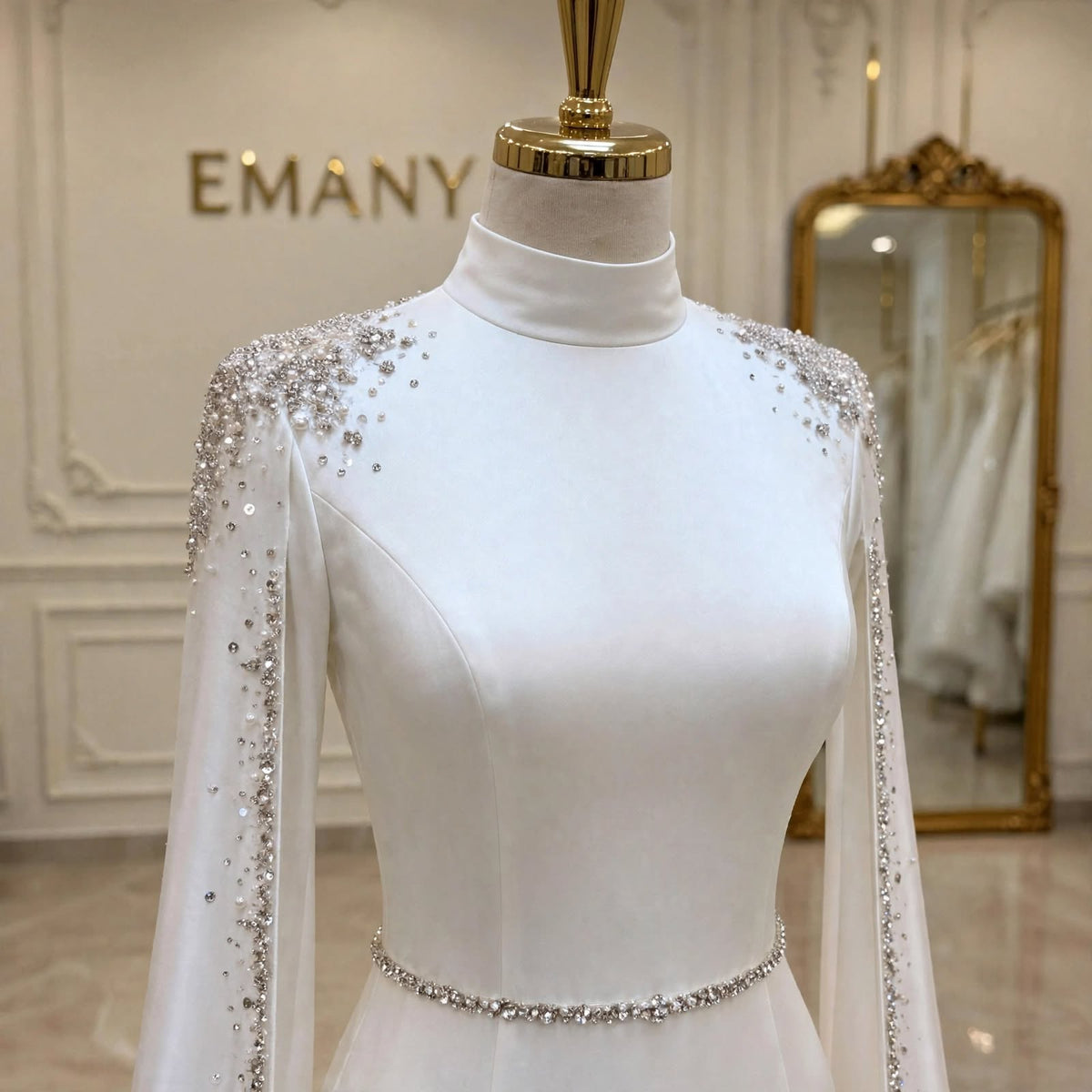 Close-up of the Elara wedding dress bodice, showcasing the elegant high neck, shoulder crystal details, and waist belt.

