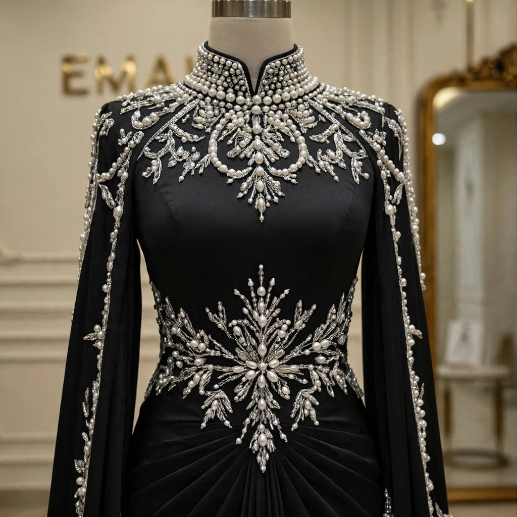 Close-up of the pearl and crystal embellished collar and bodice on the Noor Noir black evening gown by EMANY.

