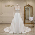 ull front view of the Rosalind satin wedding dress with pearl cuffs and illusion neckline.