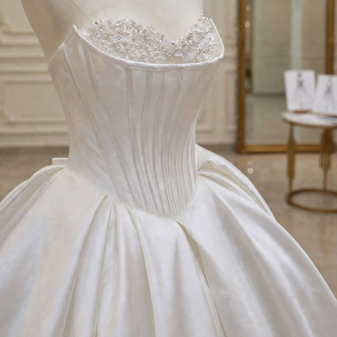Close-up of the minimalist satin corset bodice with crystal sweetheart neckline on the Selene wedding gown by EMANY.