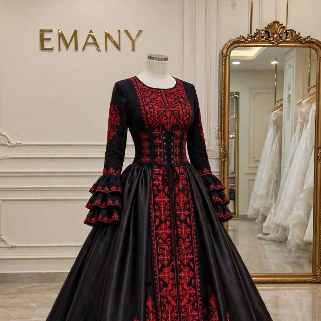 Regal black satin ballgown "Sultana" by EMANY featuring rich traditional red embroidery from neckline to hem.


