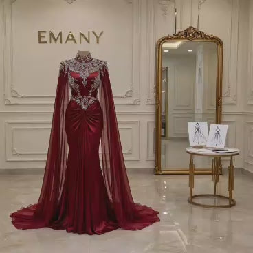 Front full view of the Scarlett burgundy mermaid evening gown by EMANY with cape sleeves - Video Preview